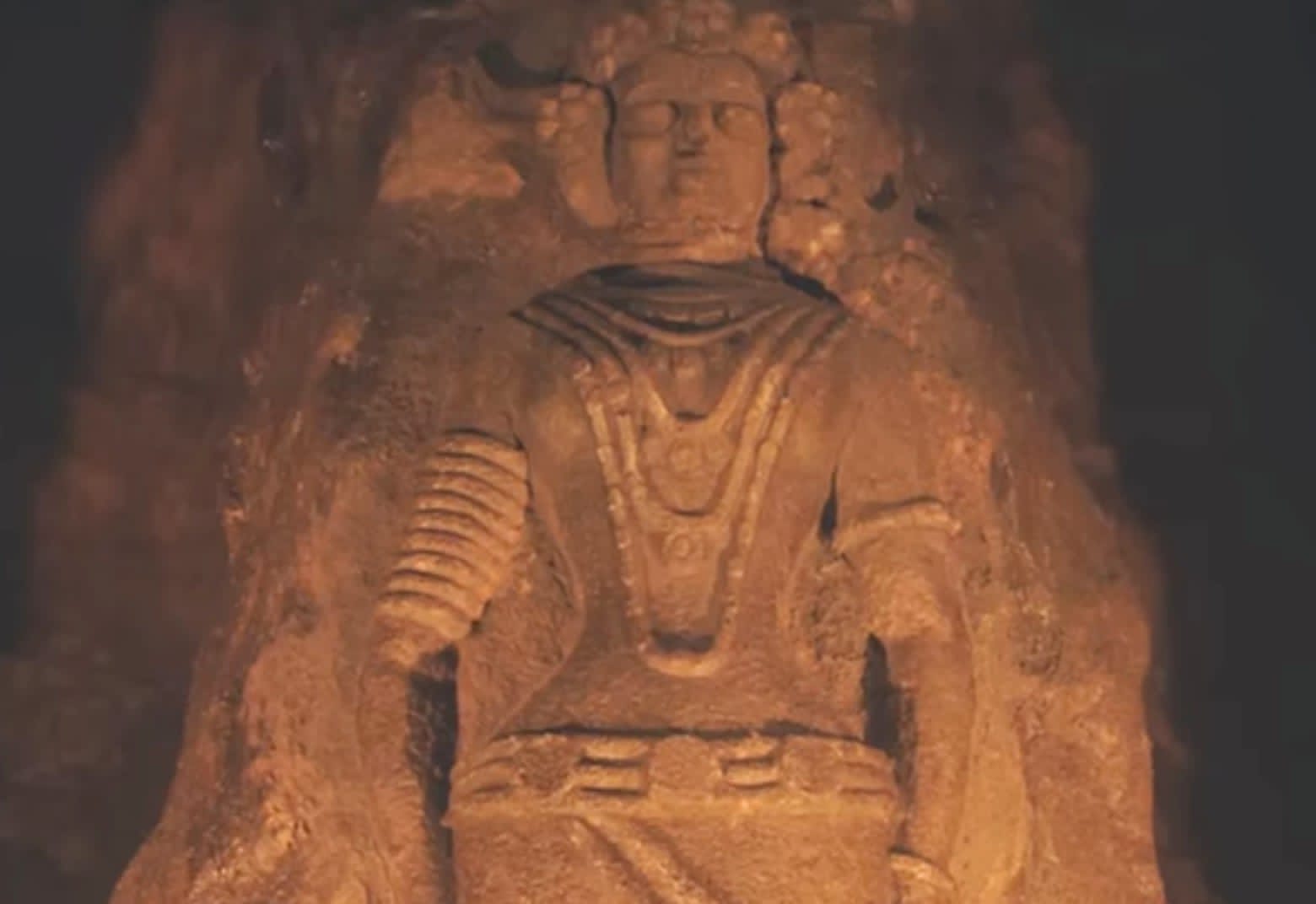 Rock-cut seated figure reference
